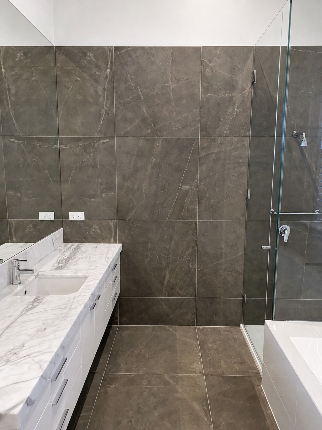 Completed large-format bathroom within the main residence