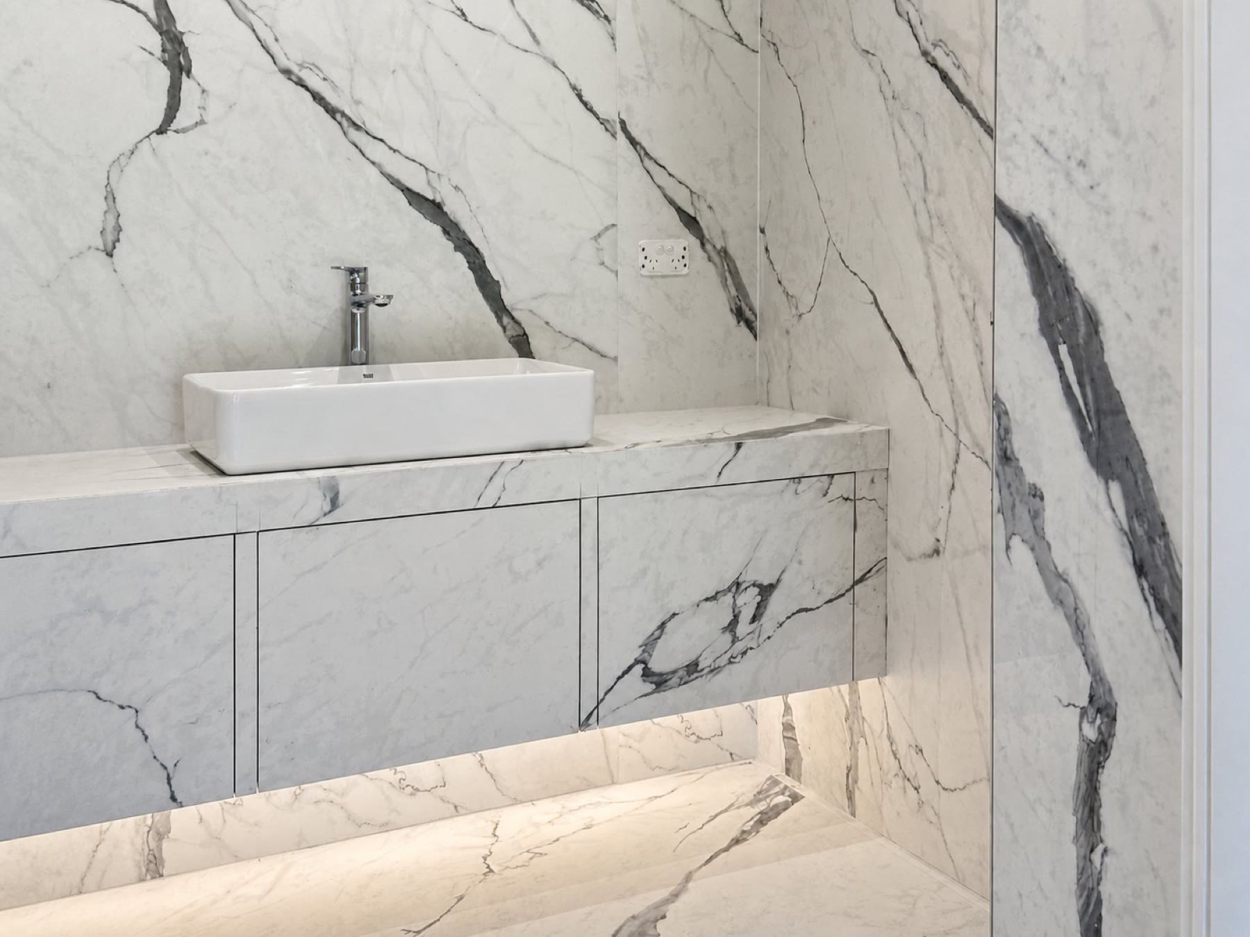 Integrated marble-look tiled vanity by Elya